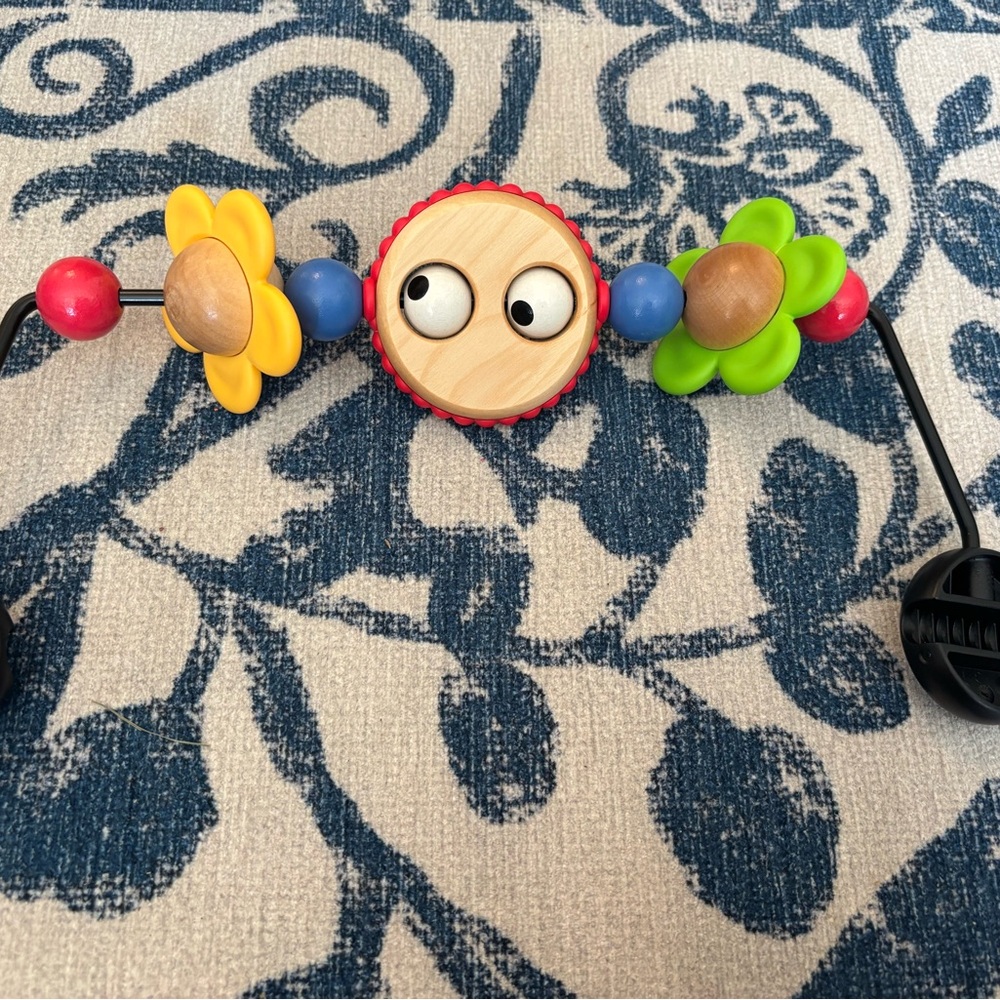 BABYBJORN Colorful Kids Toy with Flowers and googly eyes.